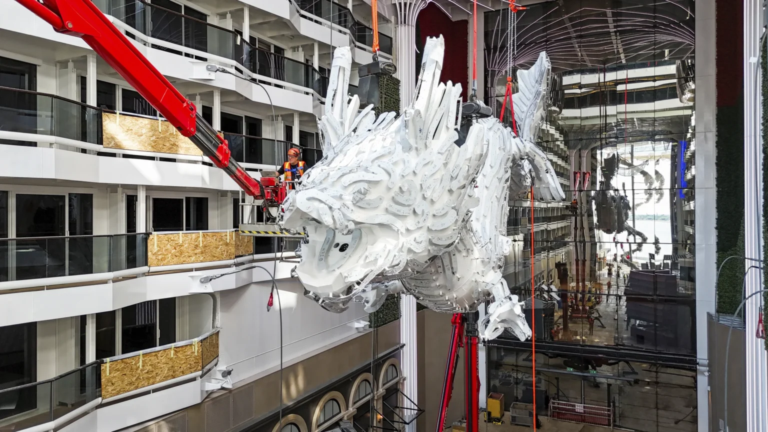 The illuminated dragon sculpture installed above the Outdoor World Promenade on MSC World Asia.